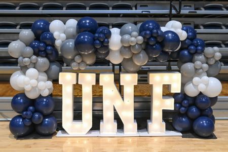 unf light sign surrounded by balloons