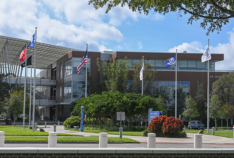 six military flags and American flag in front of the Student Union