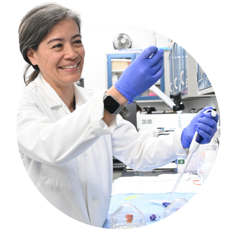 Dr. Arikawa in a lab coat piping