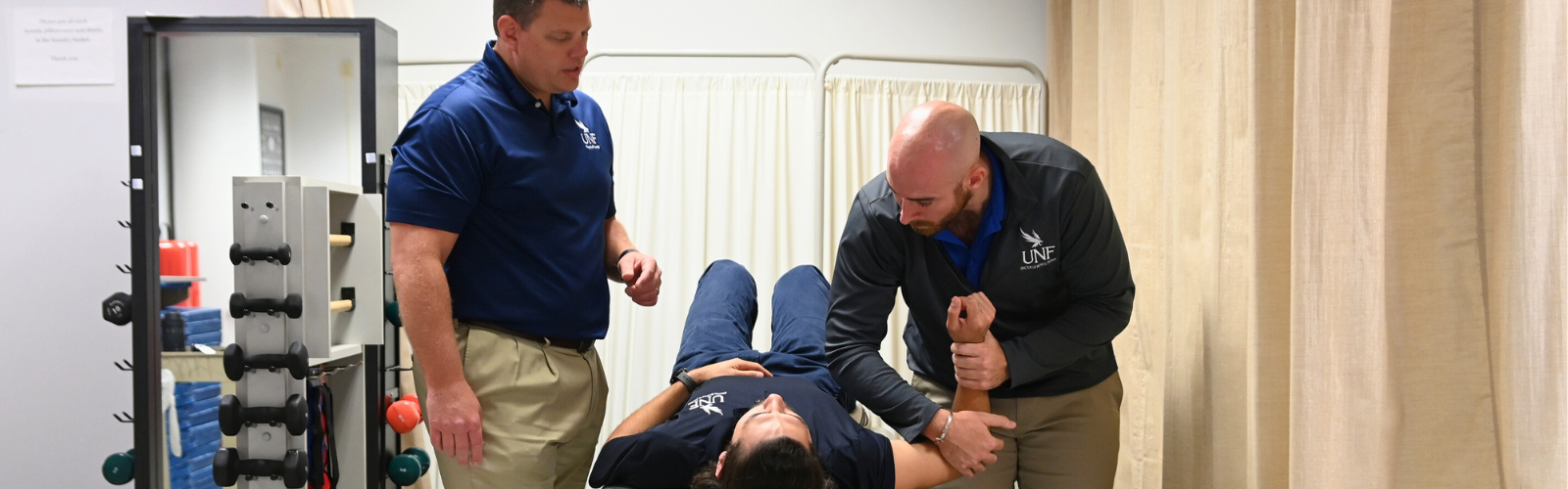 Two physical therapy professors demonstrating a stretching technique. 
