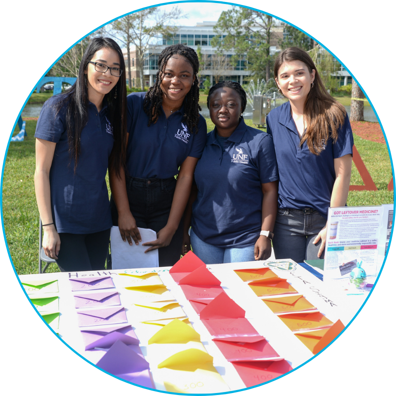 Group of UNF public students at a market day table event
