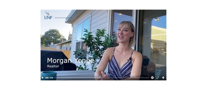 Morgan Yonge sits outside one of her properties for sale.