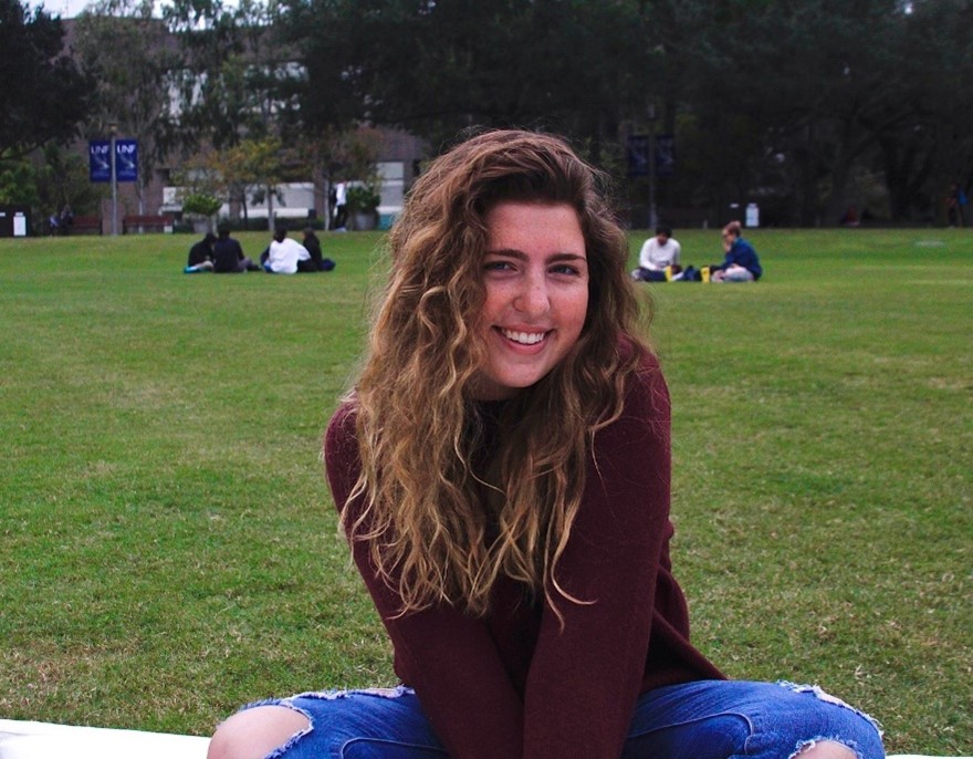 Lauren Connell sitting on grass.