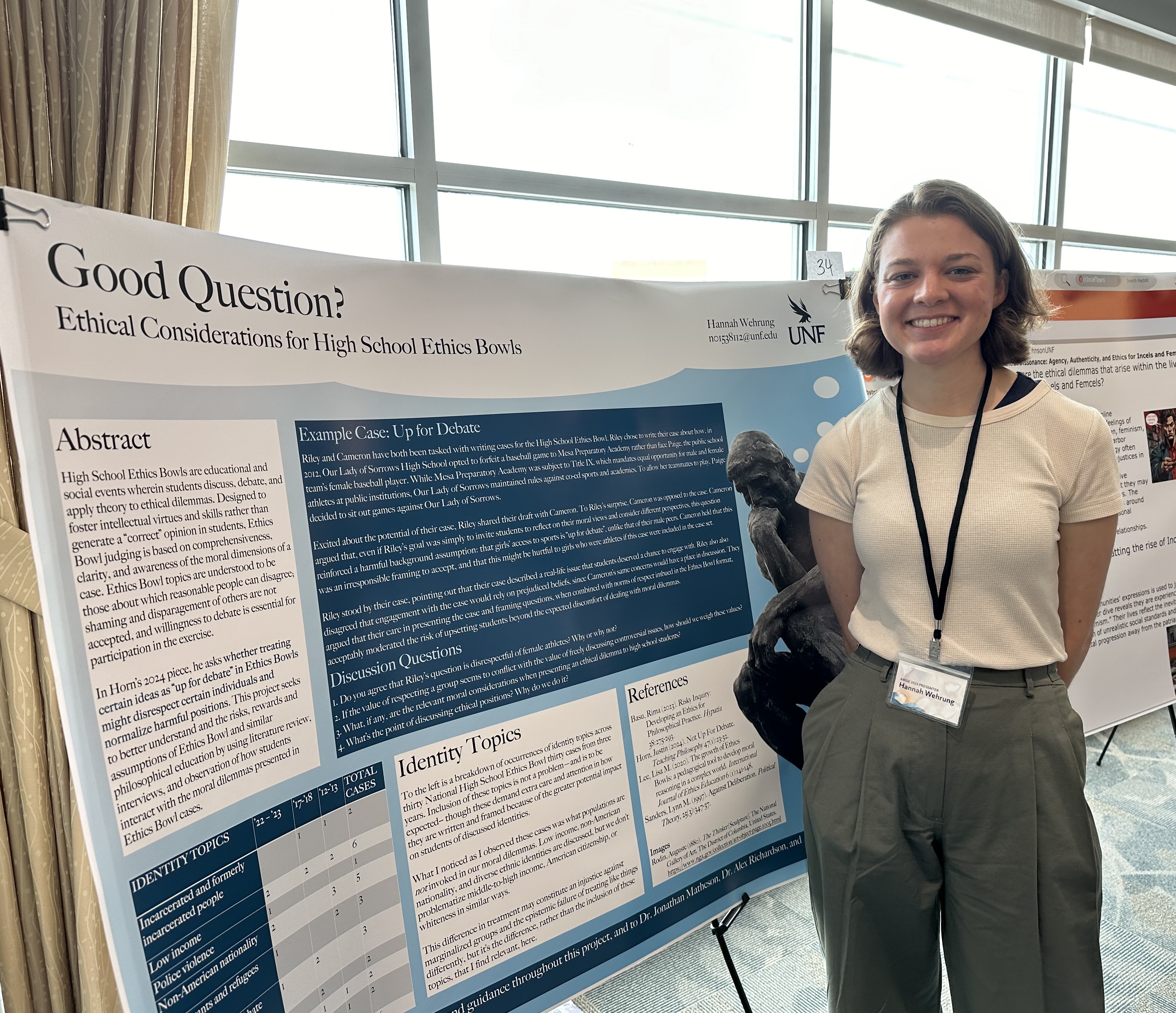 Hannah in front of her poster at the 2024 SURF Summer presentation