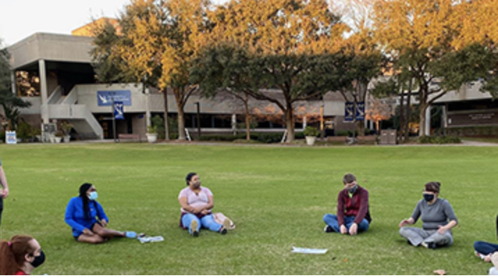 Students sitting on the UNF Green Lawn