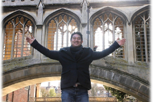 A Coggin student posing in front of a church like flying in the United Kingdom
