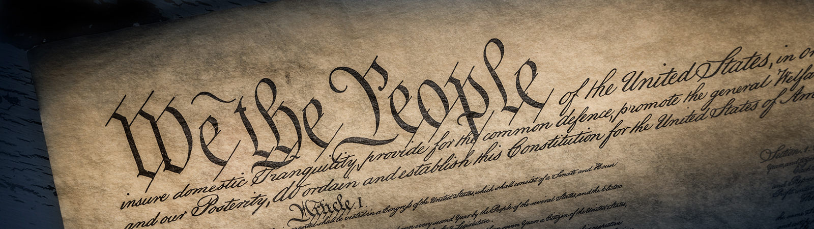 We the People on a paper copy of the U.S. constitution