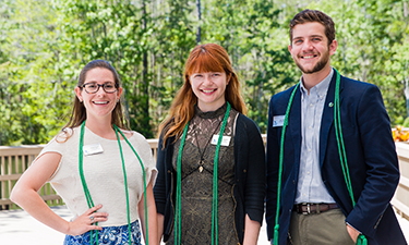 Three individuals standing outside.