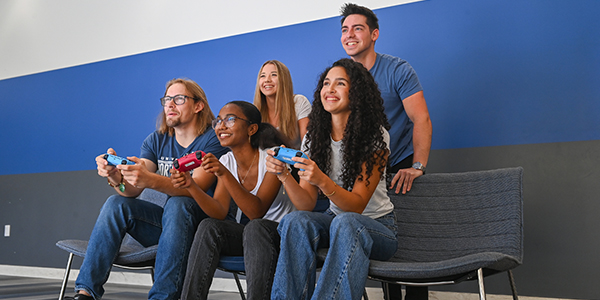 five students playing video games