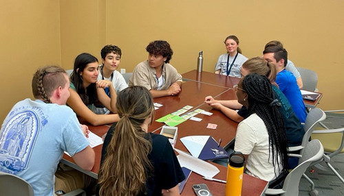Group of Ethics Interns sitting around a table doing an activity.