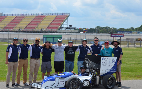 Students with Osprey Racing Group at track with car.