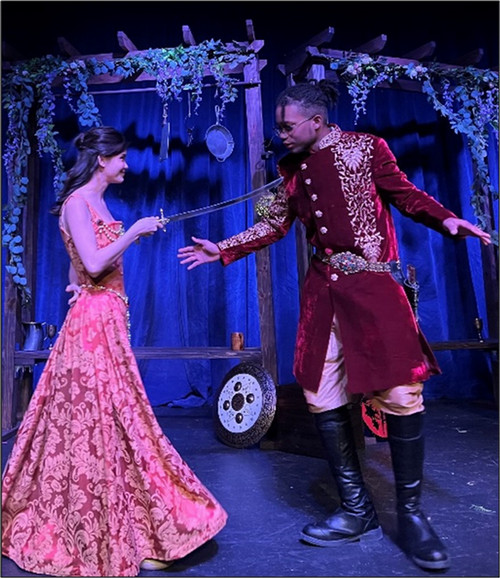 Two UNF-affiliated individuals perform a production of OTHELLO. One student is holding a sword towards the other.