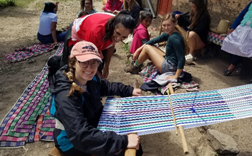 UNF student uses a loom with a community member while on a study abroad trip to Central America.