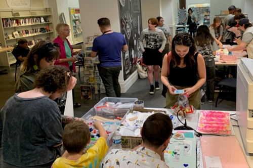 UNF students help community members at the library put together and produce lithographs.