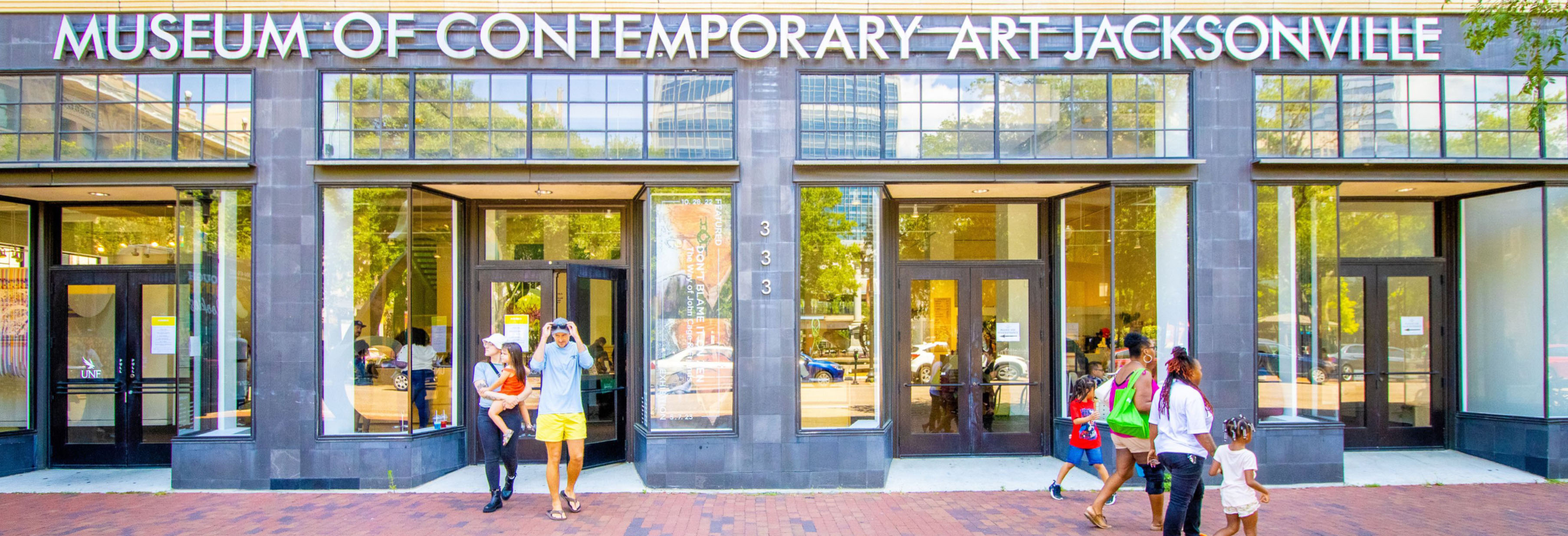 Entrance of the Museum of Contemporary Art Jacksonville with visitors walking in and out.
