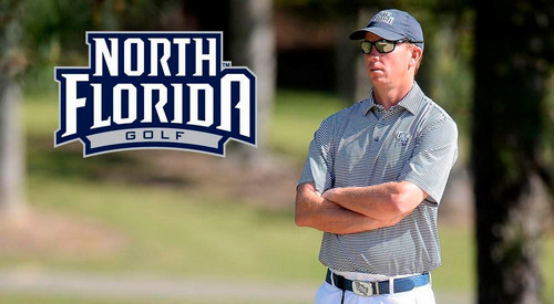 UNF head golf coach Scott Schroeder standing on golf course with arms folded