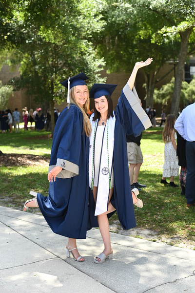 Two women in regalia at UNF's spring 2024 commencement