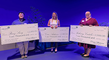 Ambassador Marilyn McAfee Scholarship recipients Boaz Levy, Cara Addison, and Bethany Castillo standing with giant checks