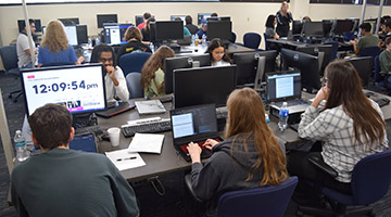 UNF students sitting at their computers creating programs