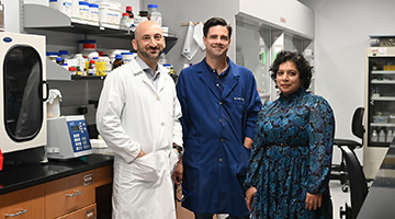 Drs. Brian Knuckley, Corey Causey and Fatima Rehman standing together in a lab setting