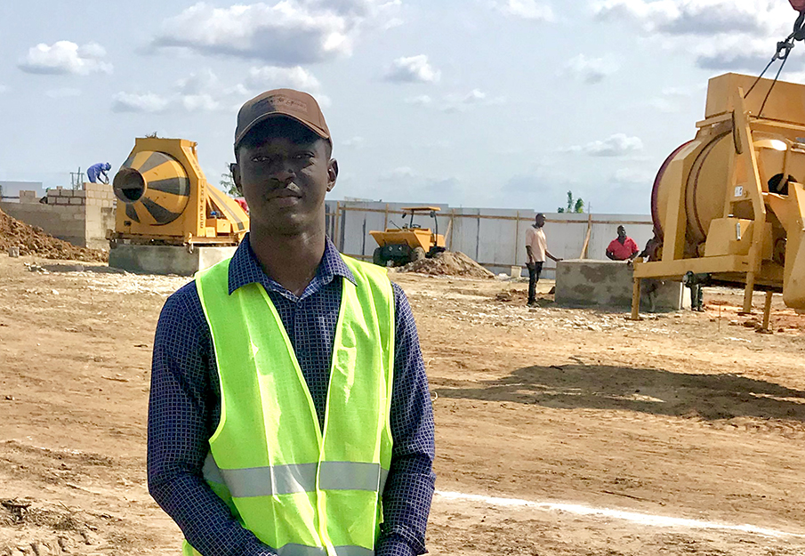 Makaya Malila standing on a construction site in Tanzania