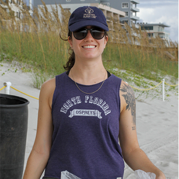 student holding a bag at the beach cleanup