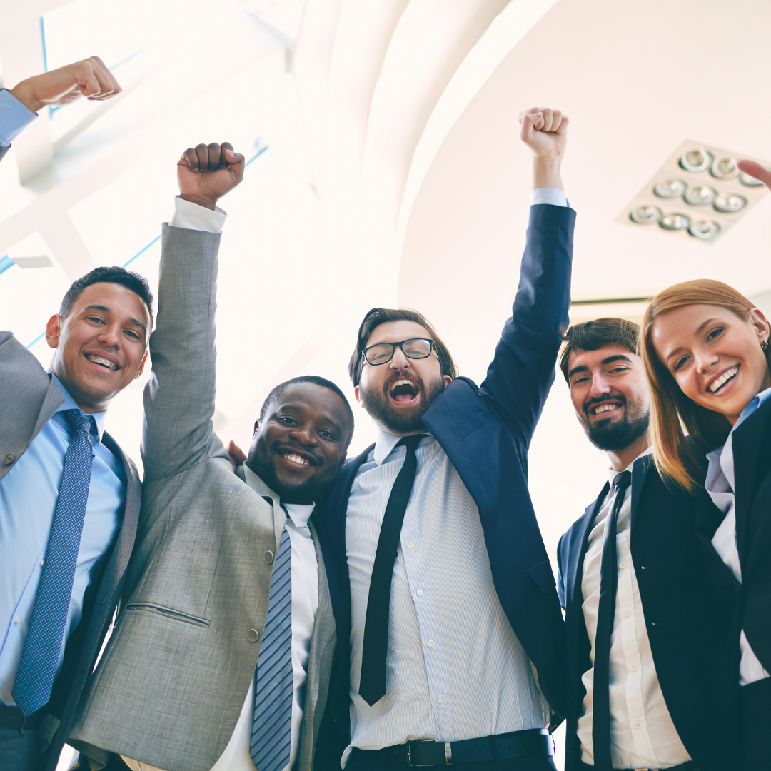 group of professionals cheering with hands in the air