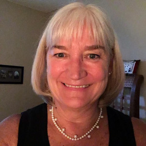 Headshot of Jean smiling