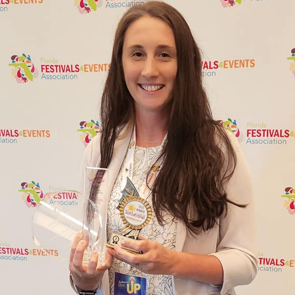 hyder holding a clear award at the festivals and events association event