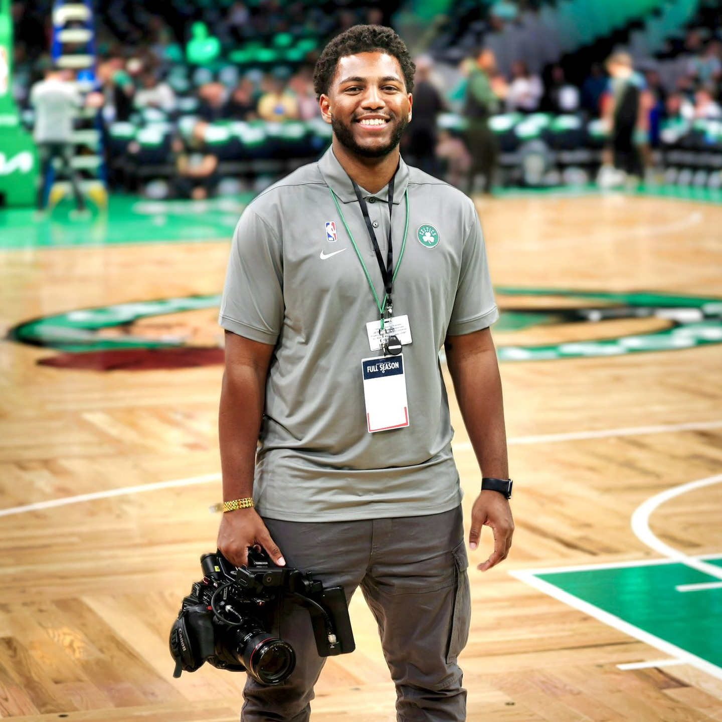 Jeremiah holding his camera at a Celtics game